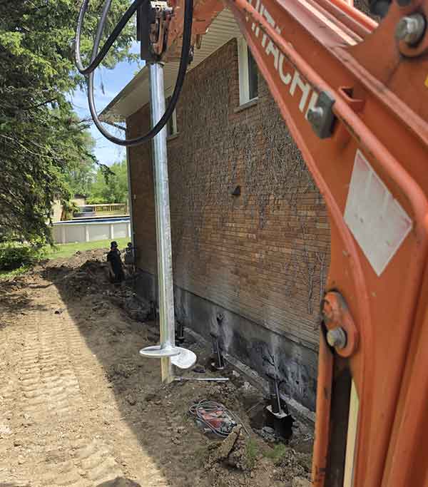 Installing helical piles in Windsor, Essex County
